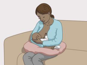 Breast-feeding example 1: the mother is sitting and the baby is lying on her arm.