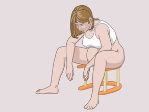 A woman relieving pain during delivery: she is sitting on a special stool.